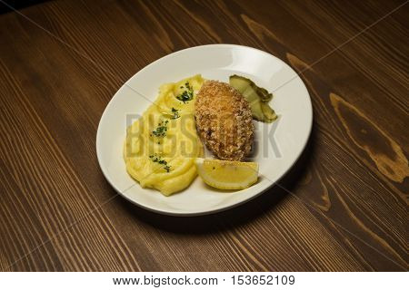 steak with mashed potatoes and pickled cucumber