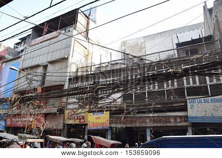 NEW DELHI, INDIA, FEBRUARY 02, 2016 - Building facades, shops and electric wires in the crowded area of Chandni Chowk in the old part of the city