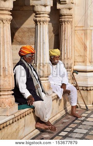 BIKANER, RAJASTHAN, INDIA - FEBRUARY 14, 2016 - Unidentified indian men sitting and resting outside Karni Mata rat temple in Deshnoke (Bikaner)