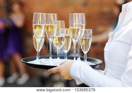 Waiter serving champagne on wedding or another festive event