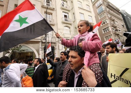 ISTANBUL,TURKEY-DECEMBER 2: Unidentified Syrians living in Istanbul protest the regime of Bashar Essad in front of Syrian Consulate on December 2, 2011 in Istanbul,Turkey.