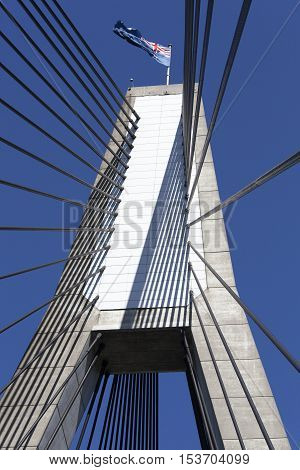 The tower of Anzac bridge with a flag on a top (Sydney New South Wales).