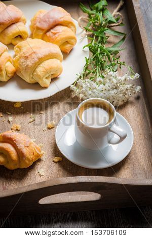 Closeup of espresso and croissant for breakfast