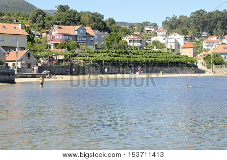 COMBARRO, SPAIN - AUGUST 6, 2016: People at the beach of the village of Combarro in the province of Pontevedra Galicia Spain