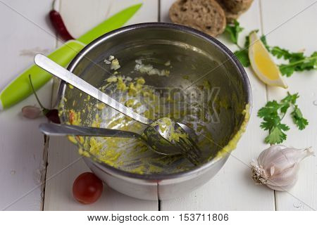 Dirty bowl on white desk after preparing fresh guacamole