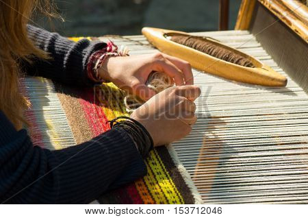 Crafts. Hand weaving loom with many colorful woolen threads.