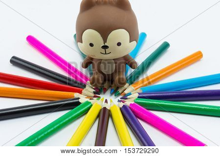Colour pencils and teddy bear shapeners isolated on white background close up