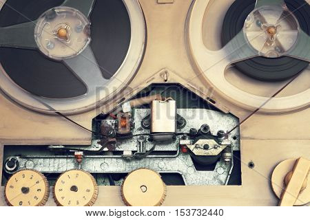 Old audio equipment. Tape recorder.The photo is tinted in a retro style.Household appliances audio retro 60s .