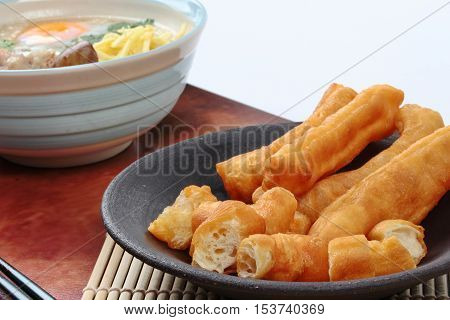 Close up of ready served as Patongko (deep-fried dough stick) . Selective focus.