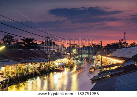 Floating market at night in Amphawa, Samut Songkhram Province, Thailand.