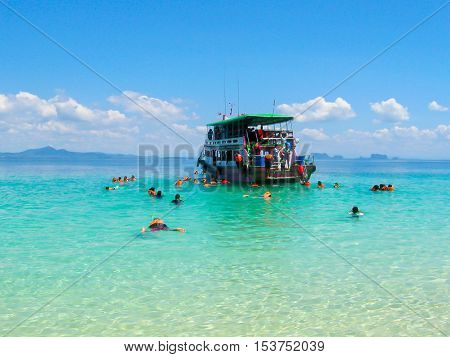 Tourists snorkeling in Andaman sea at Ko Kradan Island Thailand