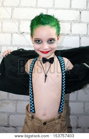 Shocking boy with green hair in the style of rock and roll.
