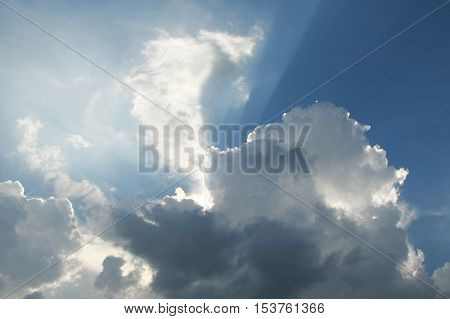 Spring bright sun illuminating clouds in the sky