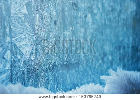 The frost on the window in cold tones. The background