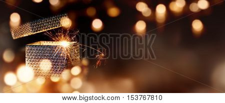 Magical gift parcel in a Panorama with golden lights and bokeh