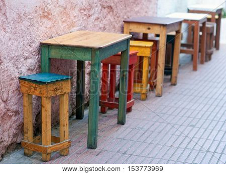 Uncovered dining tables in coffee bar on the street in Essaouira, Morocco