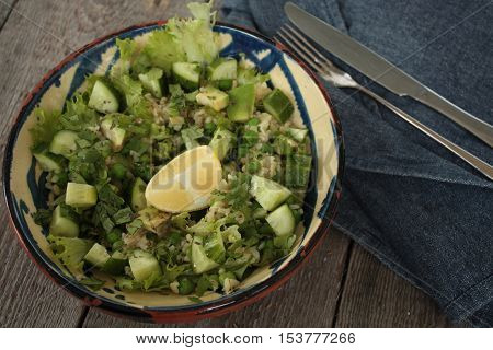 vegan healthy salad with bulgur, cucumber, avocado and crispy toast