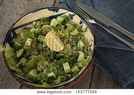 vegan healthy salad with bulgur, cucumber, avocado and crispy toast