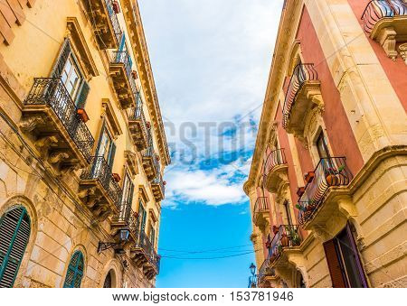 Baroque facede decorated with flowers in Italy. Beautiful travel photo. Colorful background texture with architecture and flowers.