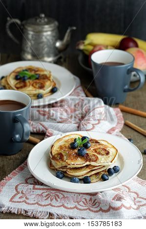 Banana pancakes with blueberry on a rustic served table