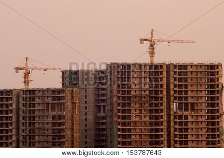 Noida, India - 16th oct 2016: Under construction buildings in Noida, Gurgaon Delhi during evening time. The crane is clearly visible on the partially completed building