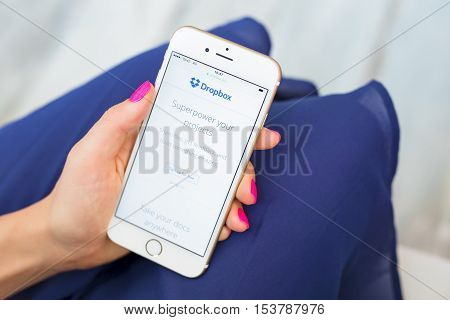 RIGA LATVIA - SEPTEMBER 8 2016: Dropbox homepage on smartphone. Dropbox is a file hosting service that offers cloud storage file synchronization personal cloud and client software.