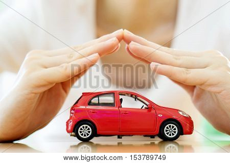 Female hands and car as protection of car concept