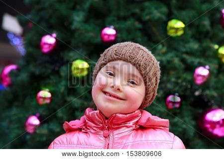 Young girl on background of the Christmas tree