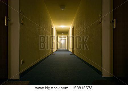 Dimly Light Corridor Hallway Apartment Complex Perspective Exit Lit Eerie Yellow Architecture
