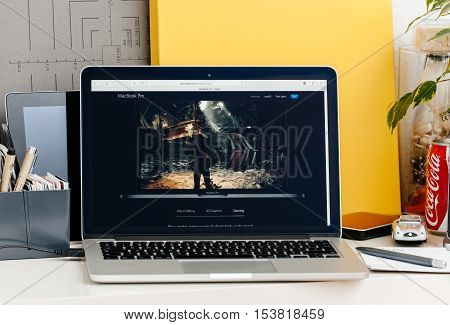 PARIS FRANCE - OCT 28 2016: Apple Computers website on new MacBook Pro Retina with OLED touch bar in a geek creative room showcasing new professional laptop - detail of game runnning on the new laptop
