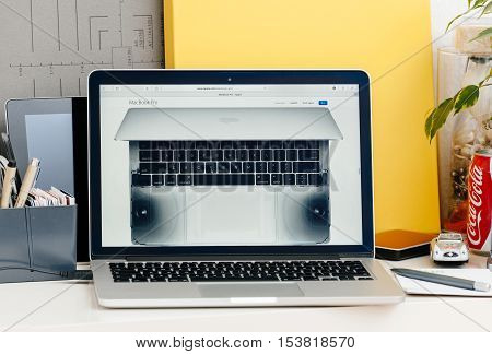 PARIS FRANCE - OCT 28 2016: Apple Computers website on new MacBook Pro Retina with OLED touch bar in a geek creative room showcasing new professional laptop - detail of