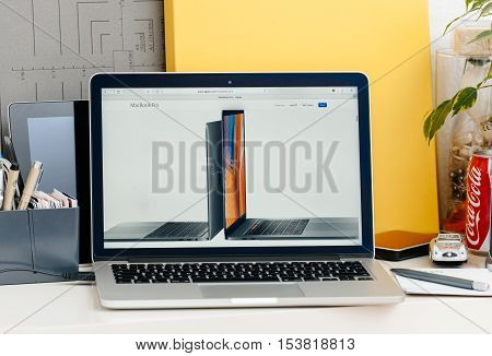 PARIS FRANCE - OCT 28 2016: Apple Computers website on new MacBook Pro Retina with OLED touch bar in a geek creative room showcasing new professional laptop - detail of 13 inch laptop and 15 inch laptop next to eachother