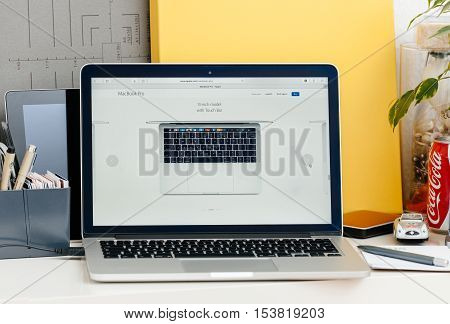PARIS FRANCE - OCT 28 2016: Apple Computers website on new MacBook Pro Retina with OLED touch bar in a geek creative room showcasing new professional laptop - 13 inch model with touch bar seen from above