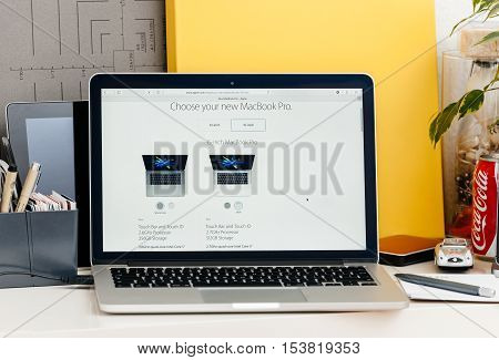 PARIS FRANCE - OCT 28 2016: Apple Computers website on new MacBook Pro Retina with OLED touch bar in a geek creative room showcasing new professional laptop - choosing the 15-inch laptop model color and specs