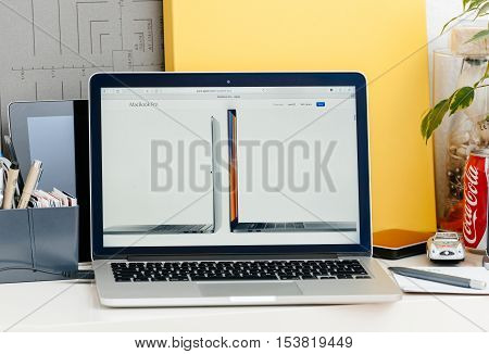 PARIS FRANCE - OCT 28 2016: Apple Computers website on new MacBook Pro Retina with OLED touch bar in a geek creative room showcasing new professional laptop - detail of 13 inch laptop and 15 inch laptop next to eachother