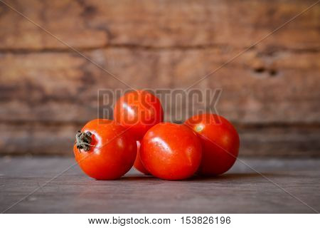 Close-up of fresh red delicious tomatoes on an old wooden table background, Copy space.