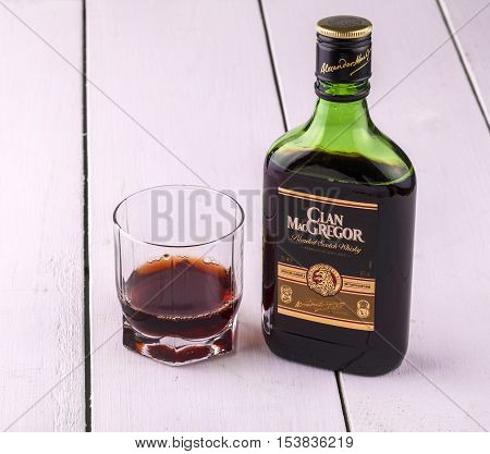 Kamchatka Russia- OCT 26 2016: whiskey from Scotland MacGregor and a glass with alcohol. Aged and especially soft Scotch whiskey. It is obtained by mixing the best fifteen Scotch whiskey with grain. The characteristic flavor of aged whiskey MacGregor talk