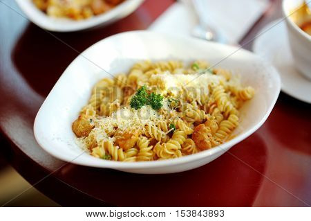 Delicious italian pasta on white plate in a restaurant