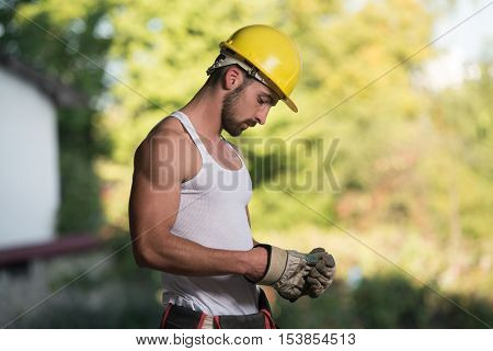 Portrait Of A Worker Takes Off The Gloves