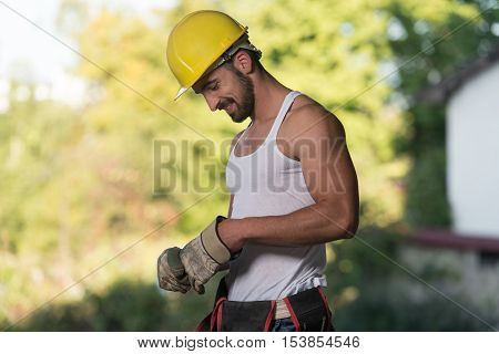 Portrait Of A Worker Takes Off The Gloves
