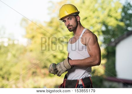 Portrait Of A Worker Takes Off The Gloves