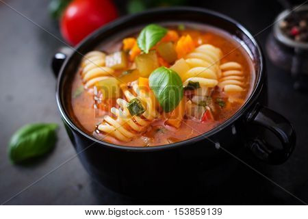 Minestrone, Italian Vegetable Soup With Pasta On Black Backgrounds.