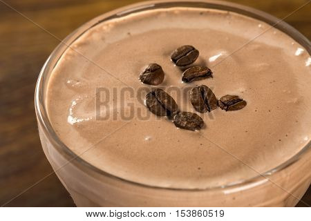 Coffee cream pannacotta selective focus. Wood background.
