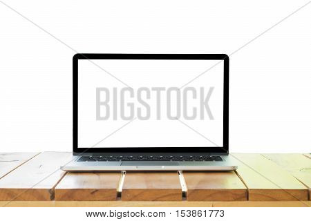 Laptop with blank screen isolated on white background white aluminium body on blue wooden desk.
