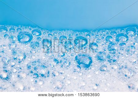 Abstract background of soap foam, suds, shower. Blue background. soft focus, macro view