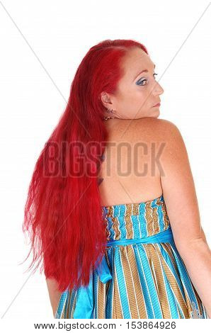 A portrait image of a woman in her thirties looking over her shoulder with long red hair isolated for white background.