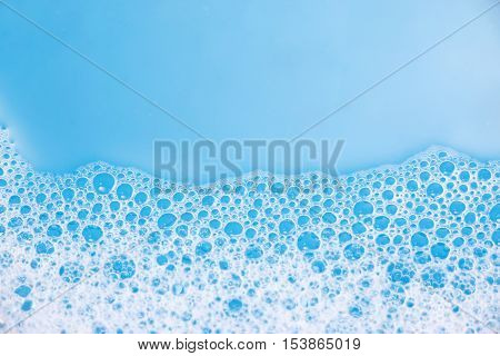 Abstract background of soap foam, suds, shower. Blue background. soft focus, macro view