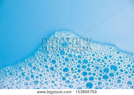 Abstract background of soap foam, suds, shower. Blue background. soft focus, macro view