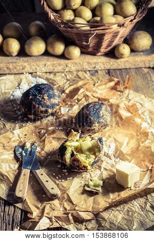 Jacket potatoes with salt and butter on old paper