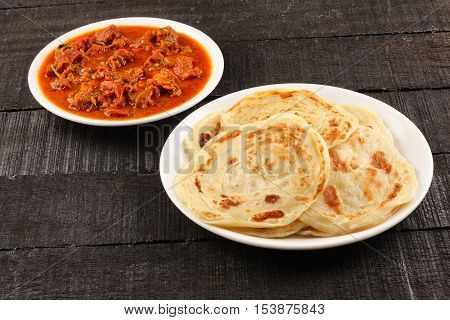 Delicious Indian street food -Paratha with spicy and tasty mutton curry.